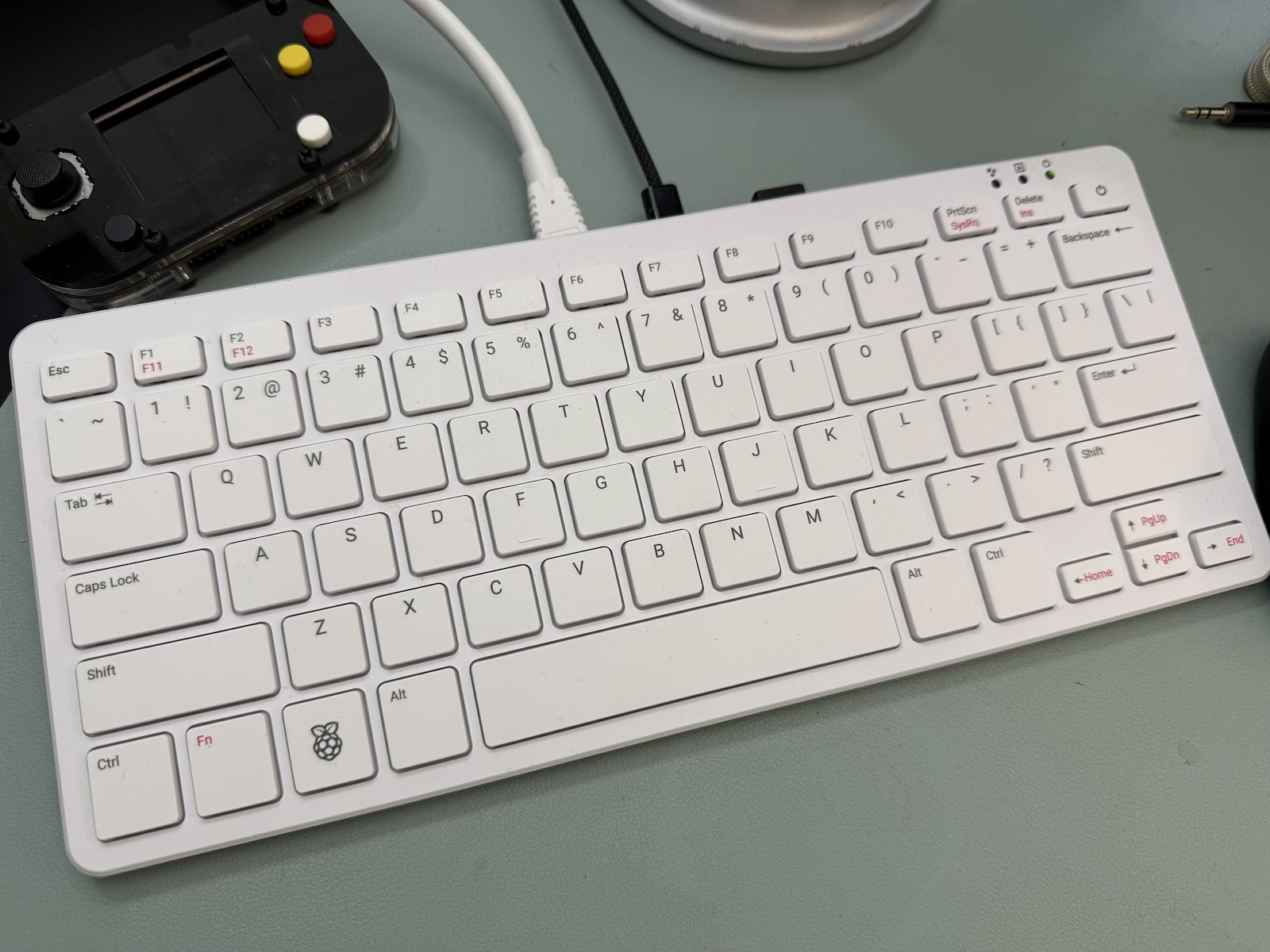 Top view of Raspberry Pi 500, a white keyboard containing a Raspberry Pi 5 computer inside.